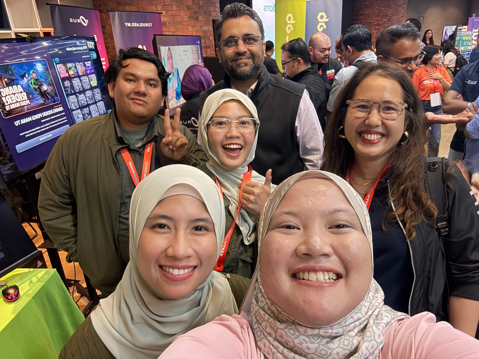 The AlteraLab team taking a selfie with Altera Coach Aidonna Jun Ayob and Shark Sameer in the busy Open Day exhibition space